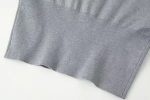 Macro view of the high-quality grey knitted ribbing texture on the slim cardigan hem