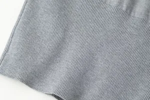 Detailed macro view of soft grey ribbed knit fabric showing fine texture and weave