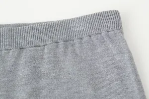 Detailed close-up view of the grey knitted shorts with elastic ribbed waistband