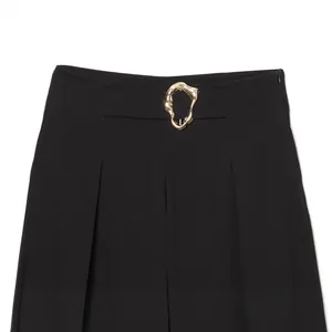 Fashionable black high-waisted bucket pants with an elegant gold fluid buckle detail
