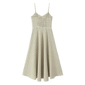Back view of a yellow plaid spaghetti strap midi dress featuring smocked back detailing