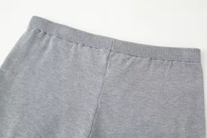 Close-up detail of a gray knitted shorts elastic waistband featuring fine ribbed texture.