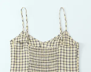 Close-up detail of plaid camisole midi dress featuring smocked back and side zipper