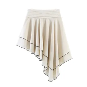 Detailed view of stylish beige asymmetric layered skirt with black contrast piping