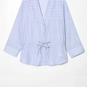 Blue and white striped V-neck blouse with waist drawstring and bow tie detail