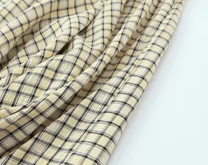 Detailed macro view of yellow and black checkered fabric with unique puckered texture