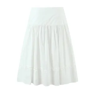 Close-up of white A-line skirt featuring elegant ruffled hem details and high-quality fabric