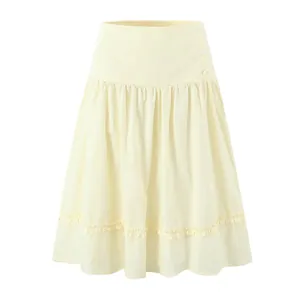 Elegant cream A-line skirt with ruffled hem and decorative buttons, minimalist detail.