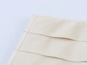 Detailed macro view of the beige layered fabric on a stylish asymmetrical skirt