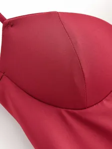 Close-up of an elegant red slimming corset top showing fine fabric texture and neat seams.