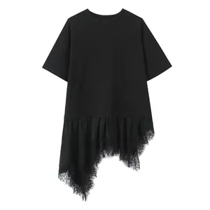 Close-up view of black T-shirt featuring an asymmetric hem and delicate lace patchwork