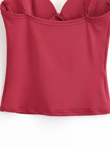 Close-up of elegant burgundy slim-fit top with smooth fabric and neat stitching.