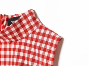 Close-up of red and white checkered high-neck sleeveless top collar detail