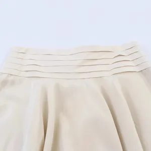 Elegant beige skirt with chic layered waist detail and smooth satin texture