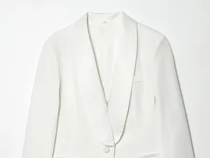 Close-up view showing the elegant shawl collar detail on a stylish white blazer