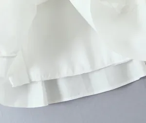 Detailed macro view of the white fabric hem and stitching on a mini A-line skirt