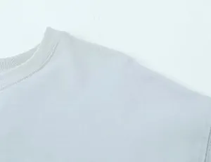 Detailed macro view showing the ribbed neckline and soft fabric of this asymmetric top.