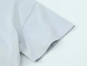 Close-up of gray T-shirt sleeve detail showing high-quality stitching and fabric