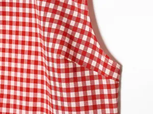 Detailed close-up showing the red and white gingham fabric texture and fine stitching work