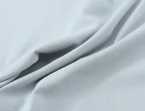 Close-up detail of light blue soft knit fabric showing fine texture and natural ripples