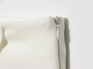 Close-up of the smooth hidden side zipper on these stylish white skirt pants