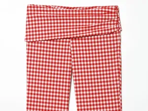 Close-up detail of red and white gingham checkered pants with fold-over waist design