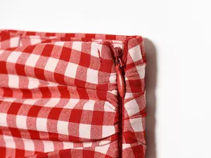 Close-up of red gingham fabric with a concealed zipper detail