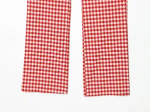 Detailed close-up view of red and white gingham checkered pattern on the pant legs