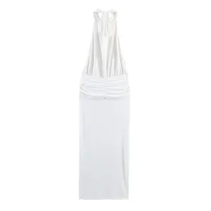 Detailed view of white halter neck dress with elegant ruched waist and tie back