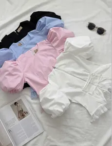Detailed view of fashion puff sleeve tops in various colors with elegant lace-up back design.