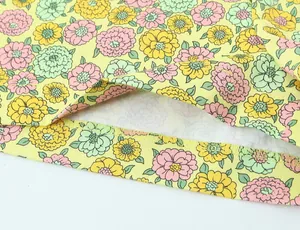 Gros plan détaillé du tissu popeline à fleurs jaunes avec couture d'ourlet nette