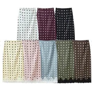 Multi-color polka dot midi skirts featuring elegant lace hem detailing.