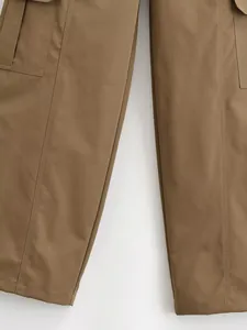 Detailed close-up of brown cargo pants showing side pocket design and double stitching