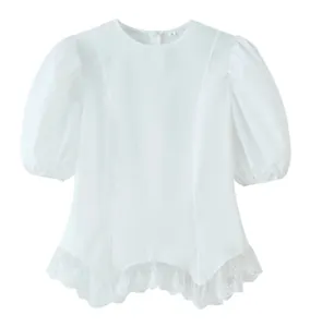 Detailed close-up of white puff sleeve blouse featuring intricate lace ruffled hem