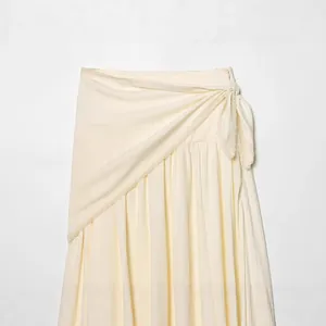 Elegant off-white wrap midi skirt featuring delicate lace trim and chic bow-tie waist design