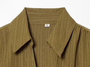 Close-up macro detail of a fashion lapel shirt collar showing vertical crinkle texture