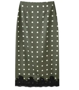 Macro detail view of olive green polka dot midi skirt featuring a black lace hem