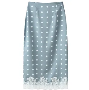 Elegant light blue polka dot midi skirt featuring intricate white lace patchwork hem detail