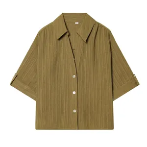 High-quality detailed view of olive green textured lapel shirt with button closure design