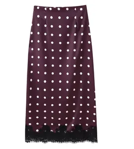 Detailed view of deep purple polka dot midi skirt with elegant black lace hem detail