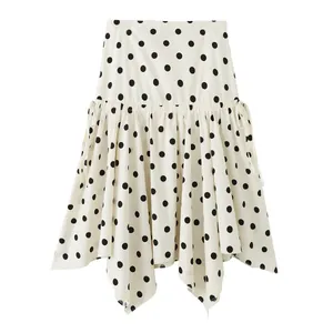 Detailed view of the asymmetrical hemline and polka dot pattern on this mini skirt