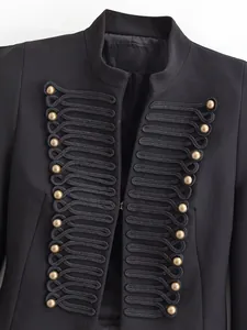 Detailed view of black military blazer with gold buttons and decorative frogging
