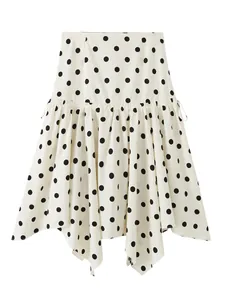 Detailed view of white polka dot mini skirt with ruffled asymmetrical hemline design