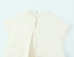 Detailed shot of white mini dress neckline featuring mandarin collar and back zipper