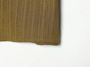 Detailed view of olive green ribbed fabric texture and hem stitching on women's set