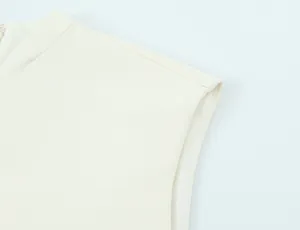 Detailed macro view of high-quality shoulder stitching on a white puffy mini dress