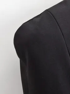 Detailed view of the structured shoulder pad on a black slim-fit blazer
