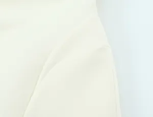 Detailed close-up of the premium white fabric and elegant pleat design on this puffy mini dress