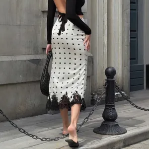 Chic polka dot midi skirt with black lace trim and high waist for women.