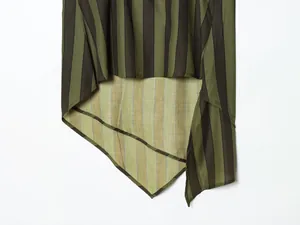 Close-up of the irregular hem on a dark green and black striped blouse.